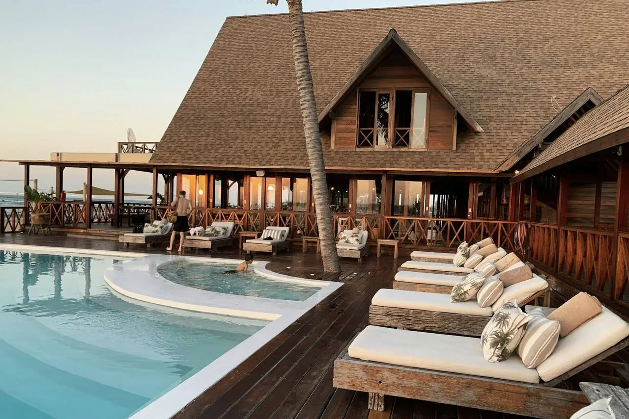 Beach resort with pool at sunset